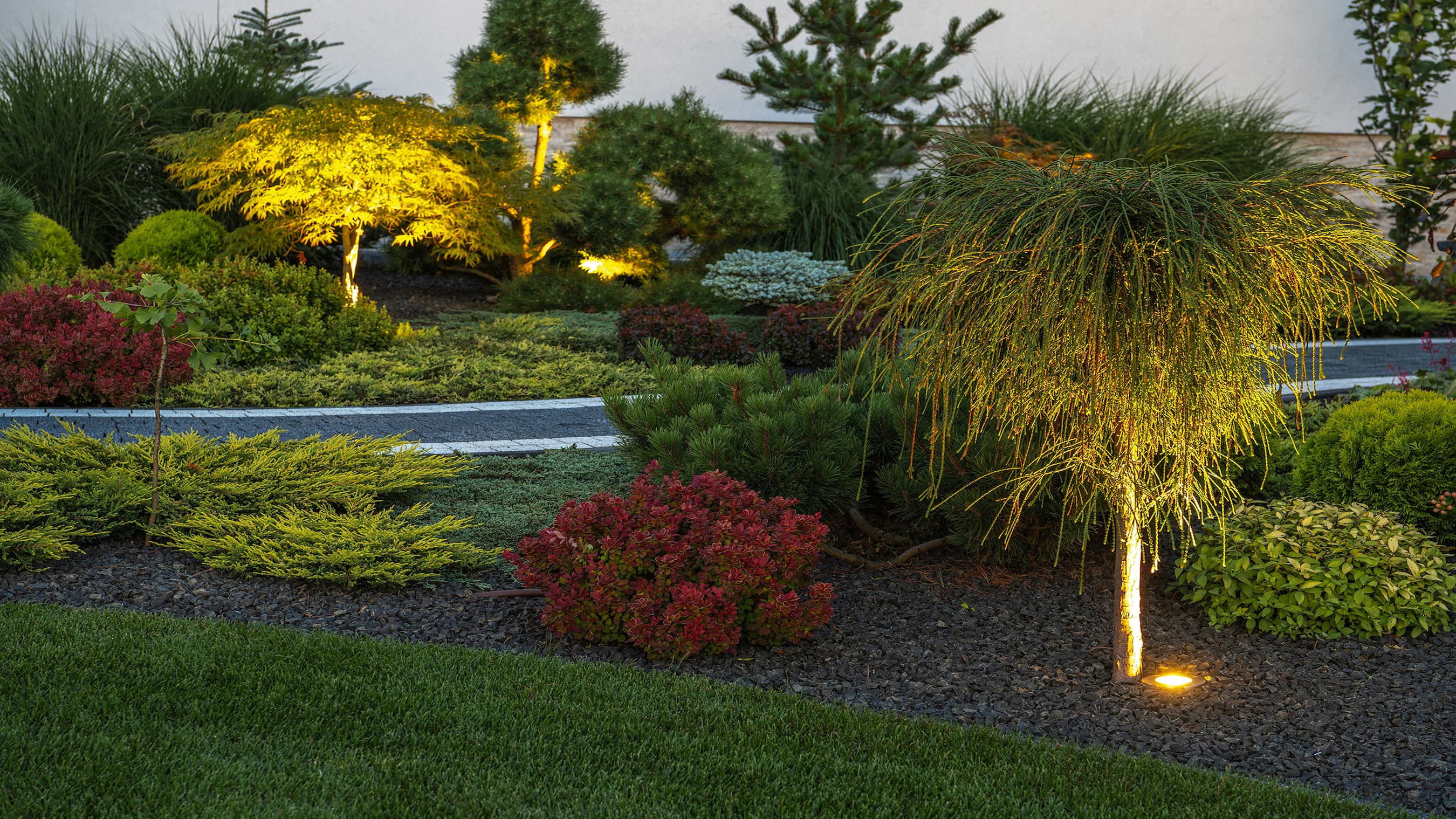 Well-manicured lawn accented by lighting