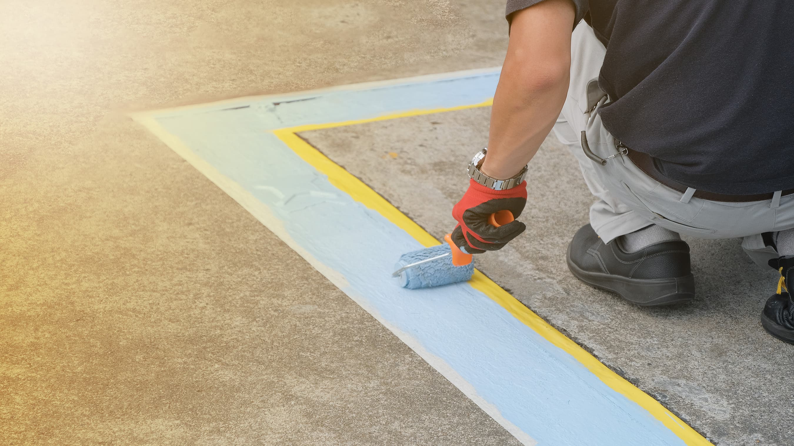 Man painting lines on a parking lot